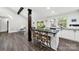 Bright kitchen with dark countertop island and hardwood floors with views of the dining area and back yard at 11914 Rock Canyon Dr, Charlotte, NC 28226