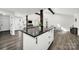Modern kitchen with dark countertop island, hardwood floors, and views of the living area and back yard at 11914 Rock Canyon Dr, Charlotte, NC 28226