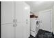 Well-organized laundry room with modern appliances and ample storage cabinets at 11914 Rock Canyon Dr, Charlotte, NC 28226