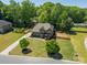 Charming brick home featuring a spacious lawn, mature trees, and a long driveway, all enclosed by a wood fence at 12525 Hashanli Pl, Matthews, NC 28105