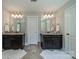This spacious main bathroom features dual sinks, granite countertops and great mirrors at 12525 Hashanli Pl, Matthews, NC 28105