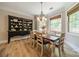 Charming dining room featuring a farmhouse table, elegant chandelier, and custom built-in shelving at 12525 Hashanli Pl, Matthews, NC 28105