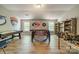 Spacious game room with pool table, foosball table, and built-in shelving for showcasing collectibles and memorabilia at 12525 Hashanli Pl, Matthews, NC 28105