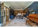 Inviting home office with brick accent wall, custom desk, and a vintage piano at 12525 Hashanli Pl, Matthews, NC 28105