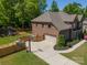 Aerial view of the home with a two-car garage, fenced yard, and play area at 12525 Hashanli Pl, Matthews, NC 28105