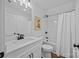 Well-lit bathroom with white vanity, shower with curtain, and wood-look floors at 130B Springway Dr, Kannapolis, NC 28081