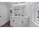 Bathroom featuring a double sink vanity with white cabinets, black hardware and faucets and large mirror at 130B Springway Dr, Kannapolis, NC 28081
