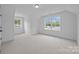 Bright bedroom featuring neutral carpet, white walls, and large windows with natural light at 130B Springway Dr, Kannapolis, NC 28081