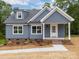 Charming, newly constructed one-story home featuring blue siding, white trim, and a welcoming front porch at 130B Springway Dr, Kannapolis, NC 28081