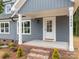 Close-up of a charming front porch with brick steps and a white front door featuring glass panes at 130B Springway Dr, Kannapolis, NC 28081