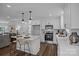 Bright kitchen with white cabinets, an island with seating, stainless appliances, and hardwood floors at 130B Springway Dr, Kannapolis, NC 28081
