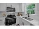 Close up of a modern kitchen featuring quartz countertops, a stainless steel sink, and stainless steel appliances at 130B Springway Dr, Kannapolis, NC 28081