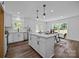 Bright kitchen with white cabinets, an island, and stainless steel appliances; natural light streams in through large windows at 130B Springway Dr, Kannapolis, NC 28081