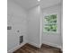 A simple laundry room with vinyl floors, window and wire rack shelving at 130B Springway Dr, Kannapolis, NC 28081
