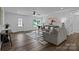 Bright living room featuring hardwood floors, neutral walls, stylish furniture, and front door at 130B Springway Dr, Kannapolis, NC 28081