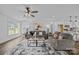 Bright living room featuring hardwood floors, neutral walls, stylish furniture, and modern ceiling fan at 130B Springway Dr, Kannapolis, NC 28081