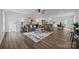 Open-concept living room featuring hardwood floors and seamless flow into the modern kitchen and dining area at 130B Springway Dr, Kannapolis, NC 28081