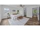 Bright and airy main bedroom featuring wood floors, a ceiling fan, two windows and an ensuite bathroom at 130B Springway Dr, Kannapolis, NC 28081