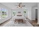 Bright main bedroom featuring wood floors, a ceiling fan, and two large windows at 130B Springway Dr, Kannapolis, NC 28081