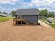 Rear view of home with a wooden deck and stairs in a spacious yard at 130B Springway Dr, Kannapolis, NC 28081