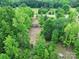 A lovely aerial view of a treed property with an existing structure on the lot at 1317 Requa Rd, Cherryville, NC 28021