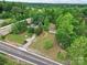 Aerial view of a residential property surrounded by lush greenery and a view of the road at 1317 Requa Rd, Cherryville, NC 28021