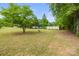 Spacious front yard featuring lush green grass and mature trees, offering a serene outdoor space at 1317 Requa Rd, Cherryville, NC 28021