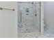 Modern bathroom with a glass-enclosed shower featuring marble tile and stylish fixtures at 1409 Bloomsberry Ln, Waxhaw, NC 28173
