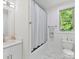 Well-lit bathroom with a granite vanity, tub with a shower curtain, and a window view at 1409 Bloomsberry Ln, Waxhaw, NC 28173