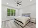 Bright bedroom with large window, ceiling fan, and luxury vinyl plank flooring at 1409 Bloomsberry Ln, Waxhaw, NC 28173