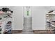 Walk-in closet view showcasing storage space with hardwood floors and a window view at 1409 Bloomsberry Ln, Waxhaw, NC 28173