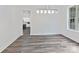 Elegant dining room with contemporary light fixture and views into kitchen at 1409 Bloomsberry Ln, Waxhaw, NC 28173