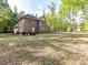 Brick home in a green, spacious yard surrounded by trees at 1409 Bloomsberry Ln, Waxhaw, NC 28173