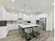 Stylish kitchen features modern appliances, white cabinets, and an island with barstools at 1409 Bloomsberry Ln, Waxhaw, NC 28173