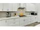 Modern kitchen featuring white cabinets, stainless steel appliances, and a sleek range hood at 1409 Bloomsberry Ln, Waxhaw, NC 28173