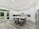 Spacious kitchen with white cabinets, an island with seating, and access to backyard at 1409 Bloomsberry Ln, Waxhaw, NC 28173