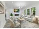 Cozy living room featuring a modern fireplace, comfortable seating, and ample lighting at 1409 Bloomsberry Ln, Waxhaw, NC 28173