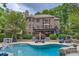 Spacious backyard with multi-level deck, ample seating areas, lush landscaping, and a sparkling pool for outdoor enjoyment at 14131 Lea Point Ct, Huntersville, NC 28078