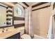 Bathroom featuring white tiles, striped walls, and a bathtub with shower at 14131 Lea Point Ct, Huntersville, NC 28078