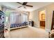 Bright bedroom with large window, ceiling fan, and a four poster canopy bed at 14131 Lea Point Ct, Huntersville, NC 28078