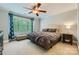 Spacious bedroom with a large window, ceiling fan, and a comfortable king size bed at 14131 Lea Point Ct, Huntersville, NC 28078
