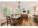 Open concept dining room with a dark wood table, hardwood floors, and living area at 14131 Lea Point Ct, Huntersville, NC 28078