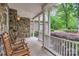 Charming front porch with stone accents and rocking chairs, inviting you to relax and enjoy the neighborhood at 14131 Lea Point Ct, Huntersville, NC 28078