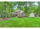 Charming home with stone and brick exterior, manicured lawn, mature trees and lush landscaping at 14131 Lea Point Ct, Huntersville, NC 28078