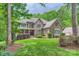 Charming home with stone and brick exterior and landscaped yard on a cloudy day at 14131 Lea Point Ct, Huntersville, NC 28078