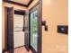 Hall laundry area with stacked washer and dryer units, conveniently located near an exterior access door at 14131 Lea Point Ct, Huntersville, NC 28078