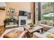 Bright living room with hardwood floors, fireplace, large windows, and built in shelving at 14131 Lea Point Ct, Huntersville, NC 28078