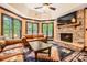 Inviting living room with a stone fireplace, leather sofas, and a large TV at 14131 Lea Point Ct, Huntersville, NC 28078