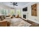 Inviting living room with fireplace, hardwood floors, lots of natural light, and comfortable seating at 14131 Lea Point Ct, Huntersville, NC 28078