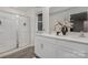 Bright bathroom featuring a double sink vanity, quartz counters, and glass-enclosed shower at 1419 5Th Street Ne Dr, Hickory, NC 28601
